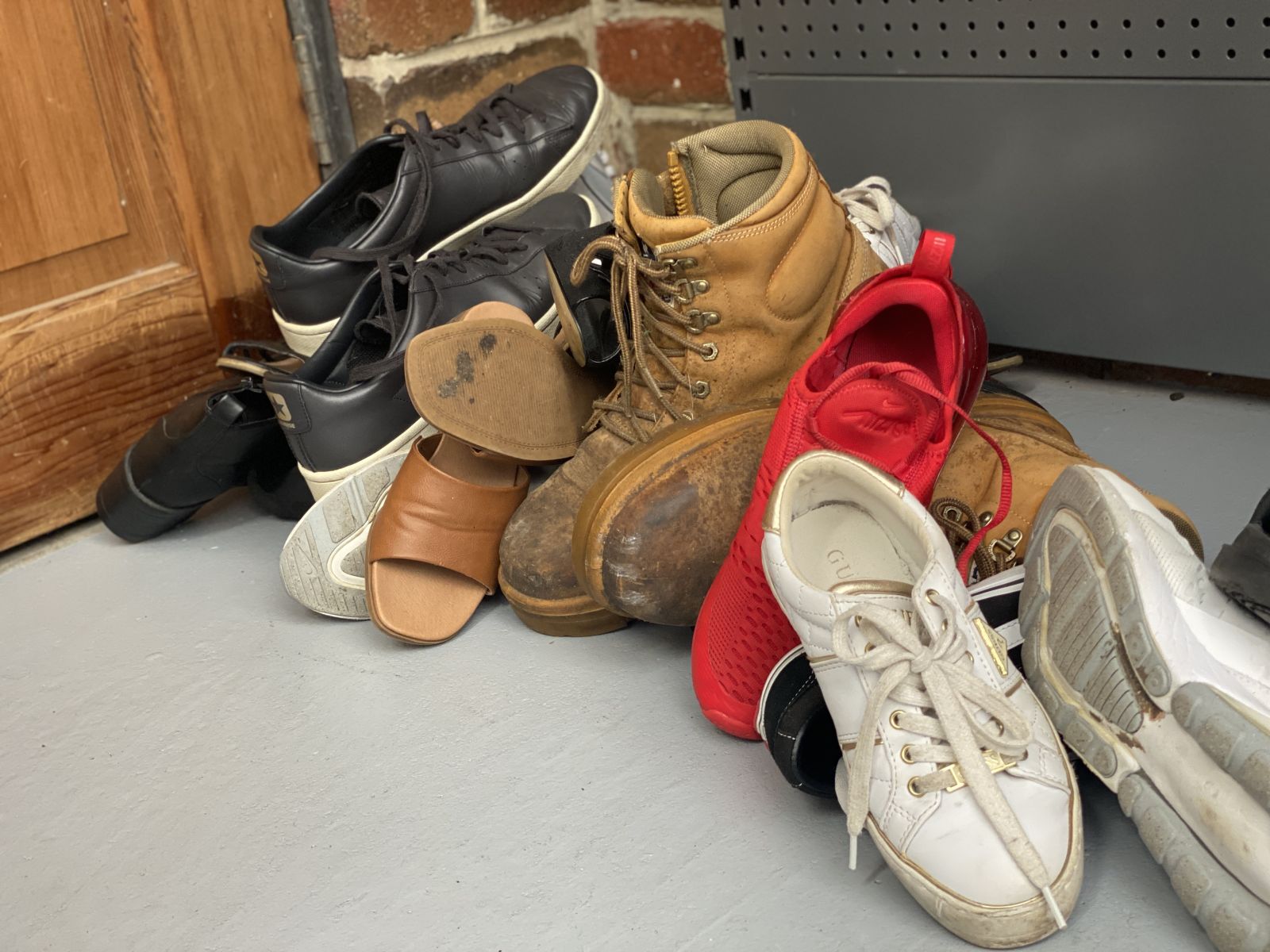 A pile of shoes in a garage 