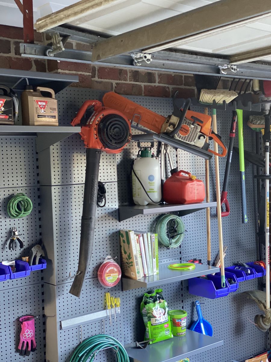 Garage storage for garden tolls and a blower