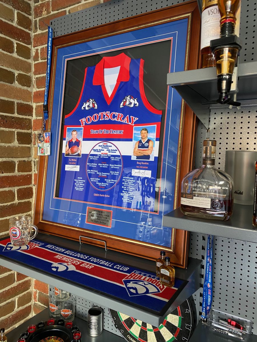 A garage bar created with GarageKing garage Storage Systems with AFL Bulldogs collectables