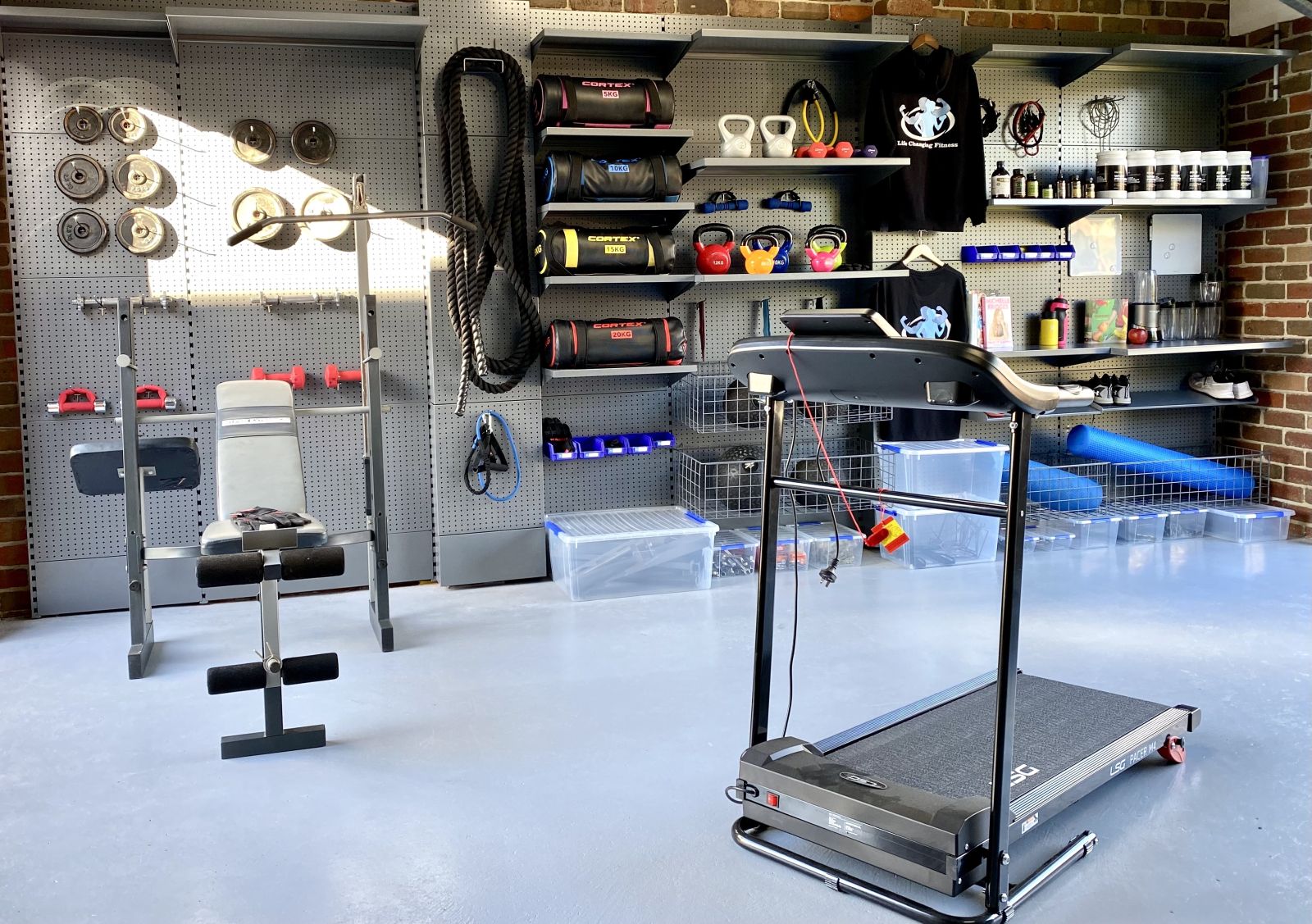 A garage home gym set up in a grey garage storage solution