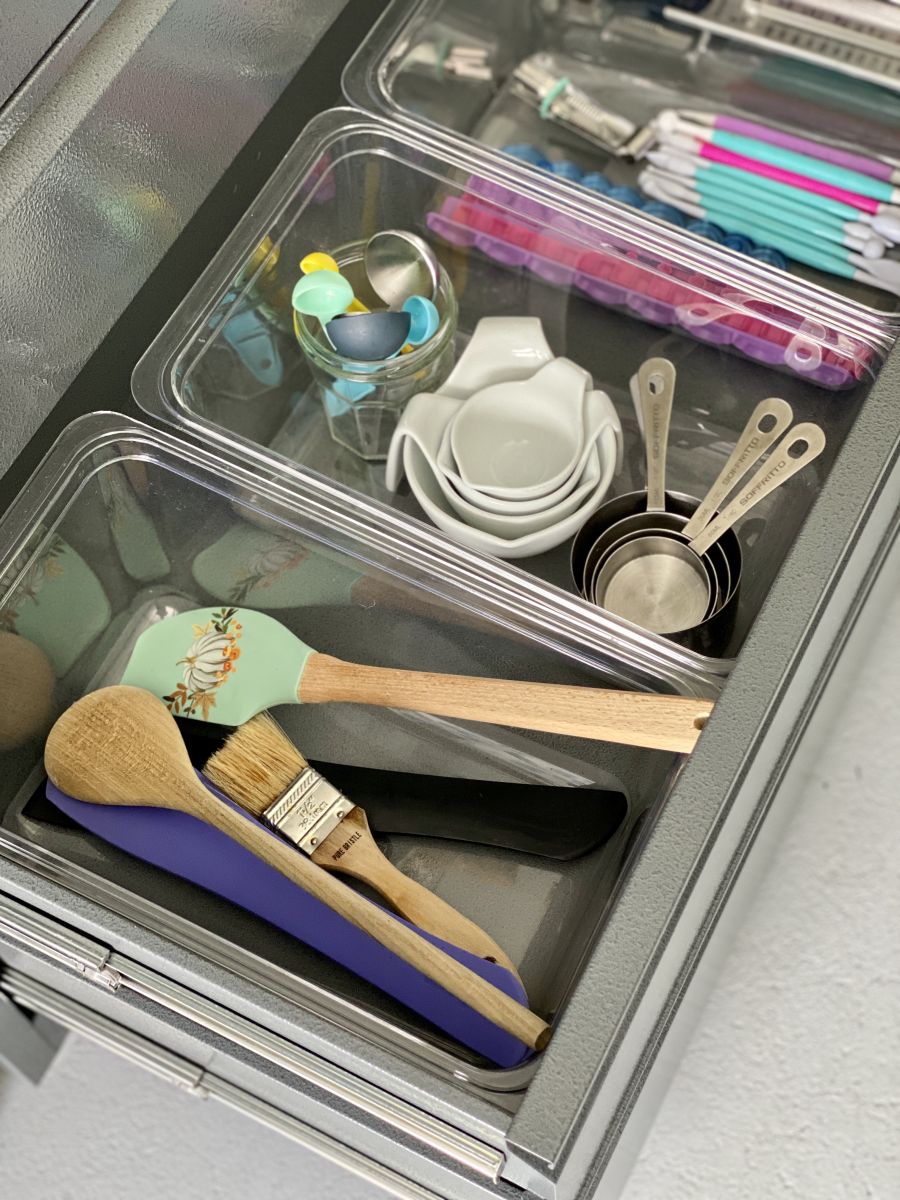 Plastic tubs in a grey metal drawer 