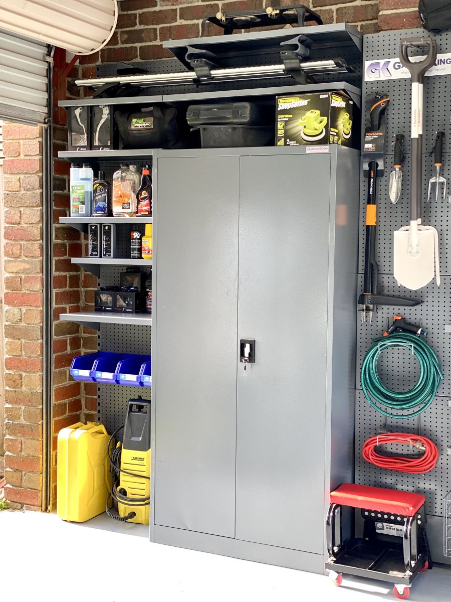 Garage storage solution with wall bays, shelves and a metal cabinet