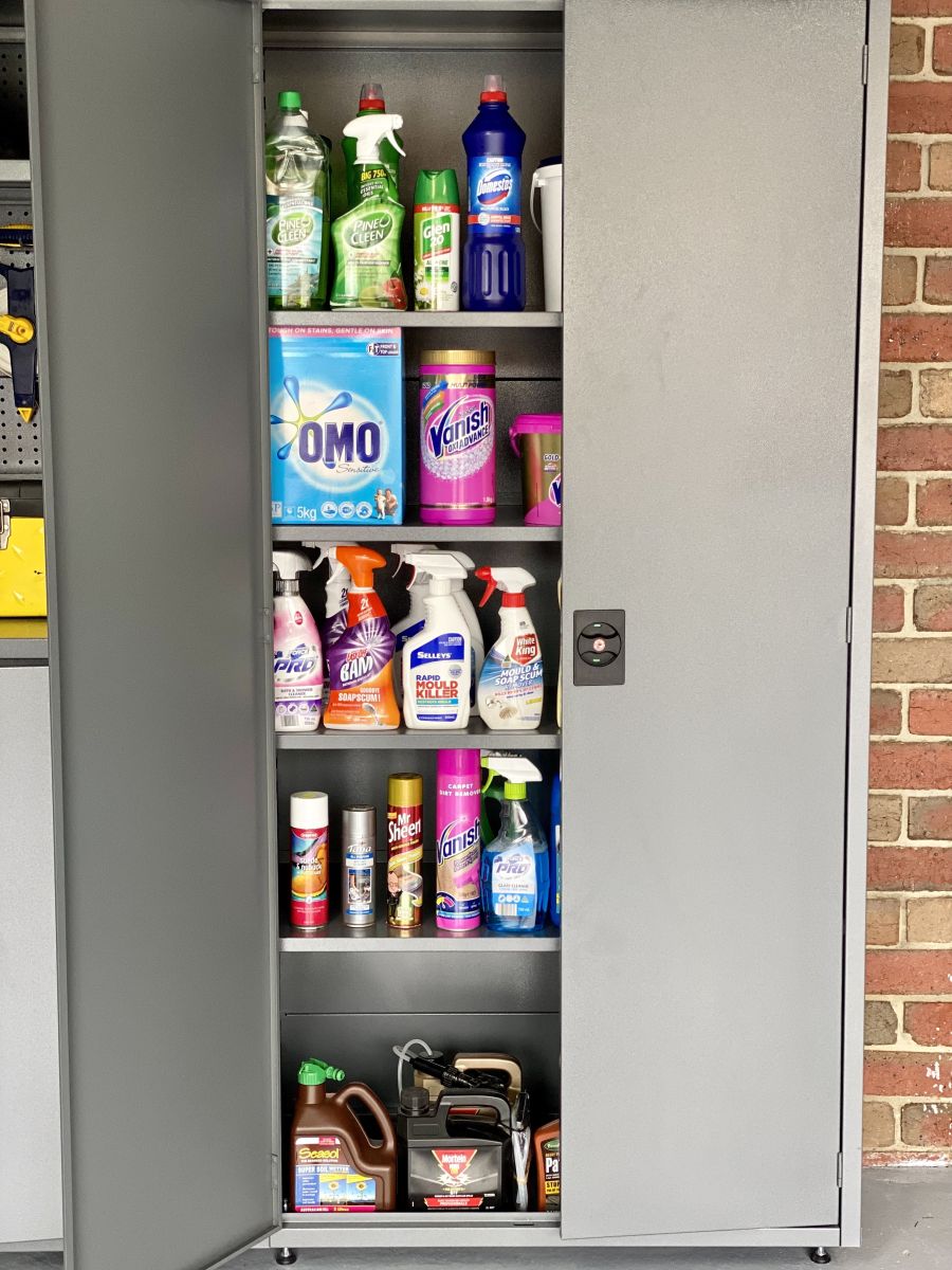 Grey metal storage cabinet with lock and household cleaning products